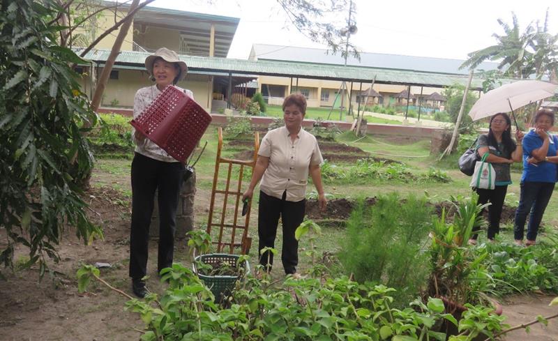 Dr. Blesilda M. Calub, Project Leader, and University Researcher from UPLB, demonstrates composting using baskets