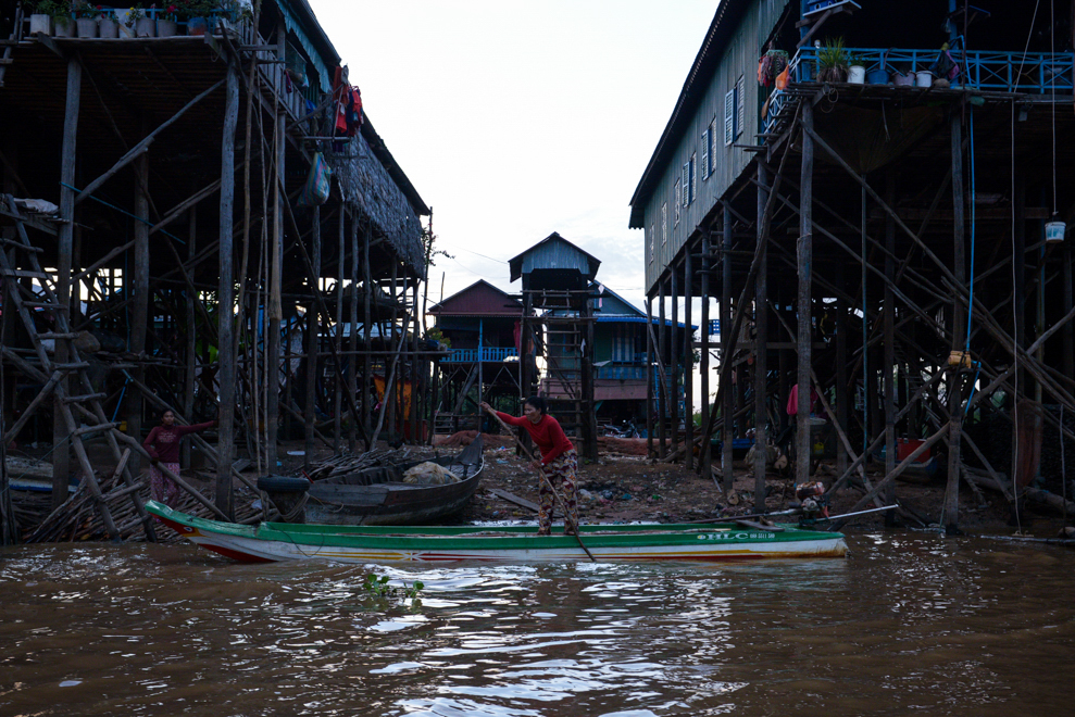 A Cambodian fisherwoman works on her boat near her house in Kompong Phluk, one of the floating villages on the Tonle Sap lake near Siem Reap. Chandan Khanna/AFP
