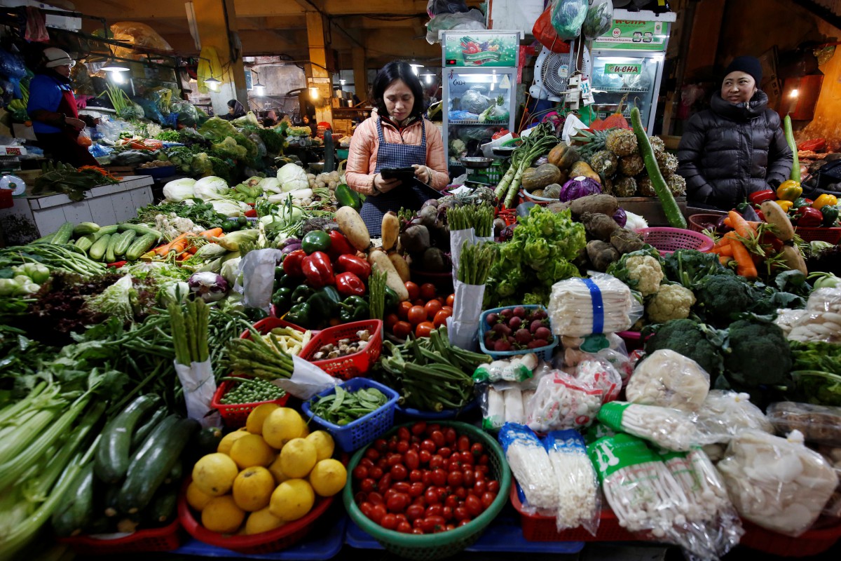 Women sell vegetables at a market in Hanoi, Vietnam, on Jan 31, 2018. Source: Reuters/Kham 