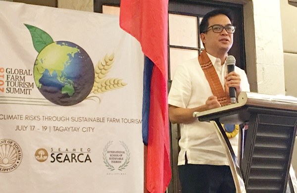 Tourism Assistant Secretary Roberto Alabado III delivers the keynote message on behalf of Philippine Tourism Secretary Bernadette Romulo-Puyat.