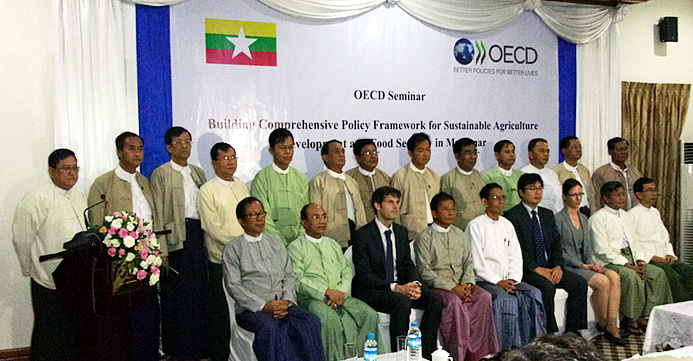 The new Union Minister of MOALI, H.E. Dr. Aung Thu (5th from left first row) and the Deputy Minister Dr. Tun Winn (4th from left first row) were joined by OECD Officers and other high Officials of MOALI led by the Permanent Secretary Dr. Tin Htut (2nd from right first row) as well as Mr. Tin Htut Oo, Chair of NESAC (1st from left first row) and YAU Rector Dr. Myo Kyew (3rd from left second row).