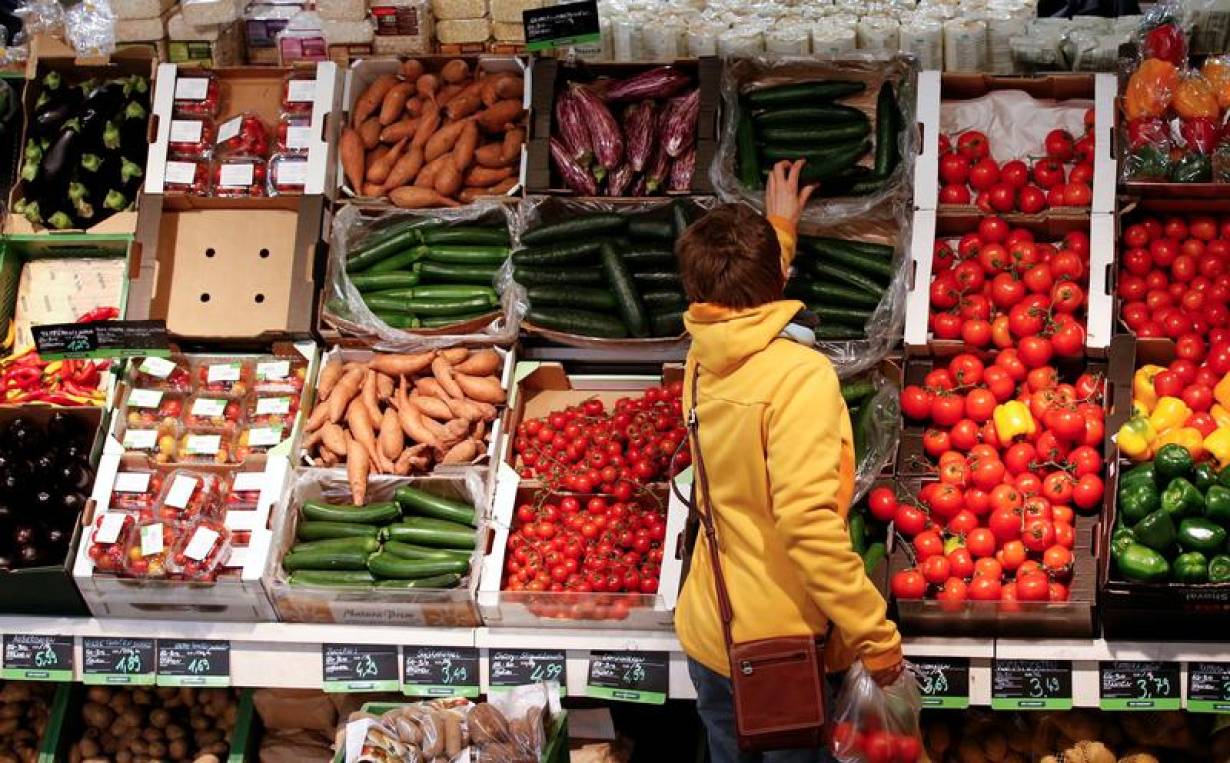 A woman checks vegetables at the Biocompany organic supermarket in Berlin, January 31, 2013. REUTERS/Fabrizio Bensch/File Photo