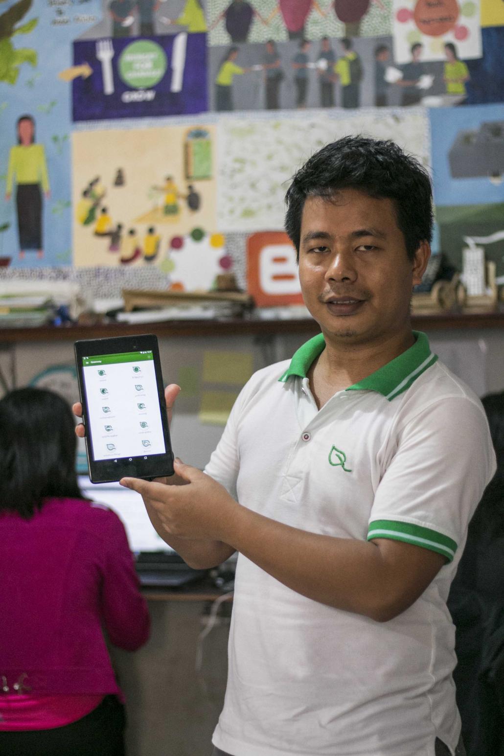 Greenovator cofounder and general manager Ko Thein Soe Min shows off the company's Green Way app. (Nyein Su Wai Kyaw Soe | Frontier)