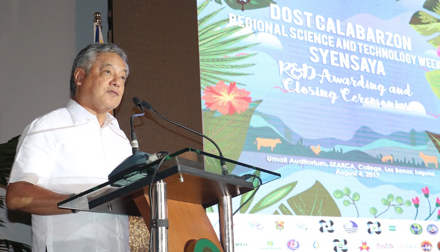 Dr. Gil C. Saguiguit, Jr., SEARCA Director, welcomes the guests to the SyenSaya R&D Awarding and Closing Ceremonies.
