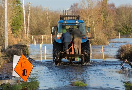 Ferrying neighbours through the floods at Mukanagh, Athlone in 2015. Picture: Fergal Phillips