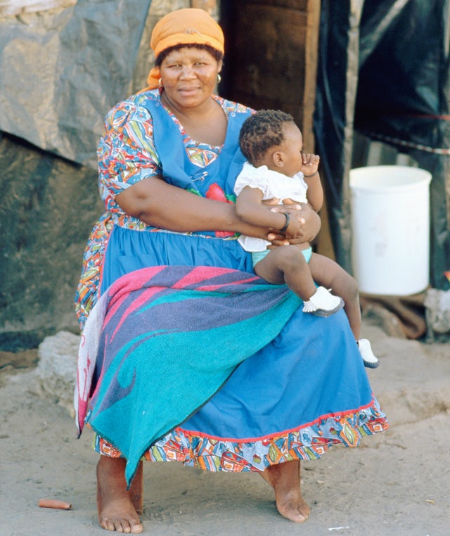A South African woman sits with her child in Crossroads township.Peter Turnley/Corbis/VCG via Getty Images