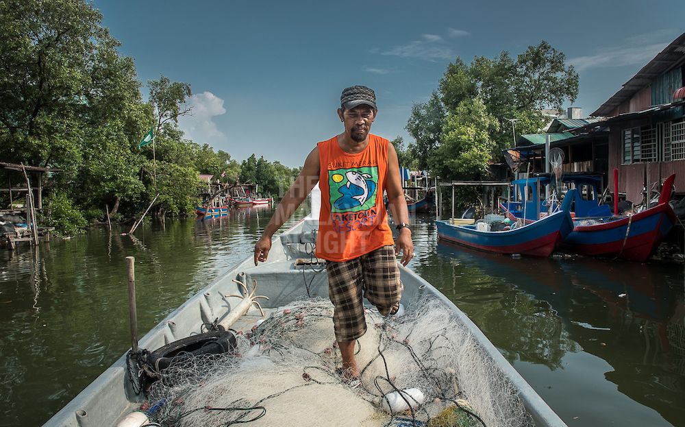 Fisherman Badrul Hisham Hashim, 49, at the Sungai Kluang fishing village in Bayan Lepas. Penang’s fishing communities have been struck by the ill effects of changing sea currents, due in part to the state’s land reclamation projects. – The Malaysian Insight pic by David ST Loh, March 3, 2018.