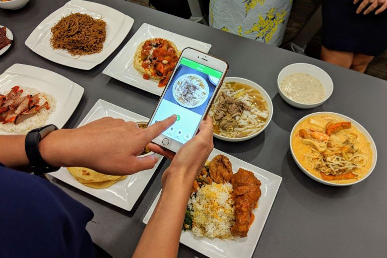 The JurongHealth Food Log app uses AI to match uploaded photos of food to a database of over 200 common local dishes, including nasi padang, laksa and char siew rice. ST PHOTO: REI KUROHI