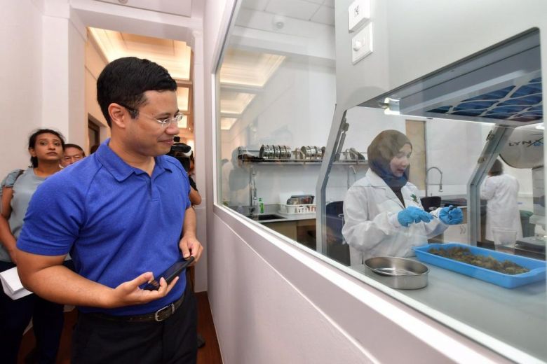 Minister for Social and Family Development and Second Minister for National Development Desmond Lee at Singapore Botanic Gardens Seed Bank observing lab work where seeds are cleaned.ST PHOTO: NG SOR LUAN