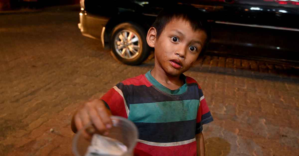 This file photo taken on 11 October, 2019 shows a boy begging for loose change along a street in Jakarta. (AFP Photo)