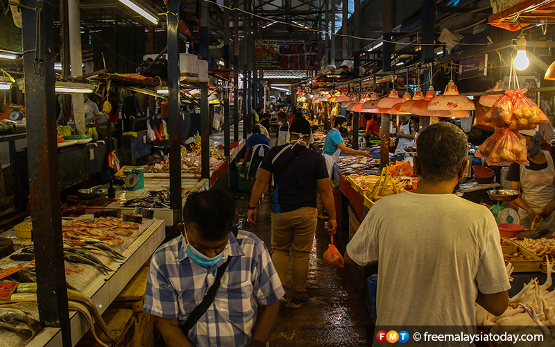 Customers browse for supplies at the Chow Kit market in Kuala Lumpur as the government’s movement control order enters its third week.