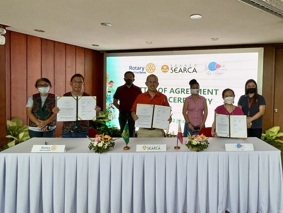 Dr. Glenn B. Gregorio (center), SEARCA Director; Mr. Manolito Pinca (second from left), RCLB Makiling President; and Ms. Armi Shyr Anastacio-Baticados (second from right), LATCH LB Coordinator; each holds a copy of the LOA between SEARCA, RCLB Makiling, and LATCH LB that they inked in a signing ceremony on 3 March 2022. The ceremonial signing was witnessed by Assoc. Prof. Joselito G. Florendo (third from left), SEARCA Deputy Director for Administration; Ms. Maria Elisa Ronan (leftmost), RCLB Makiling Treasurer; Ms. Myla Beatriz A. Gregorio (third from right), LATCH LB Counselor; and a representative from the Municipal Nutrition Action Office (MNAO).